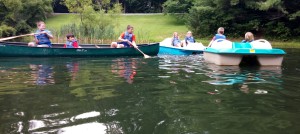 Canoes and paddle boats float towards each other at Camp Bretheren Woods with the Summer Enrichment Program's class "Ready, Set, Go!" on Wednesday July 15th, 2015. Photo by Irene Liu.